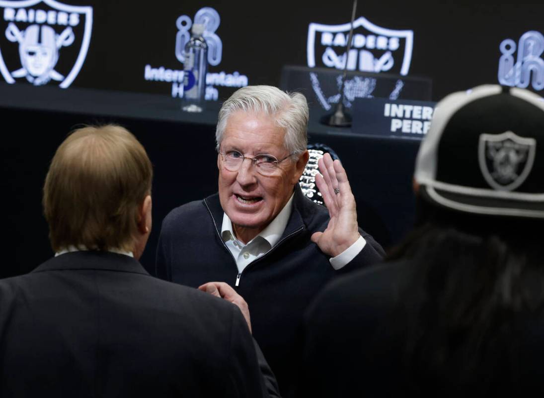 Raiders owner Mark Davis, left, chats with the new head coach Pete Carroll after a press confer ...