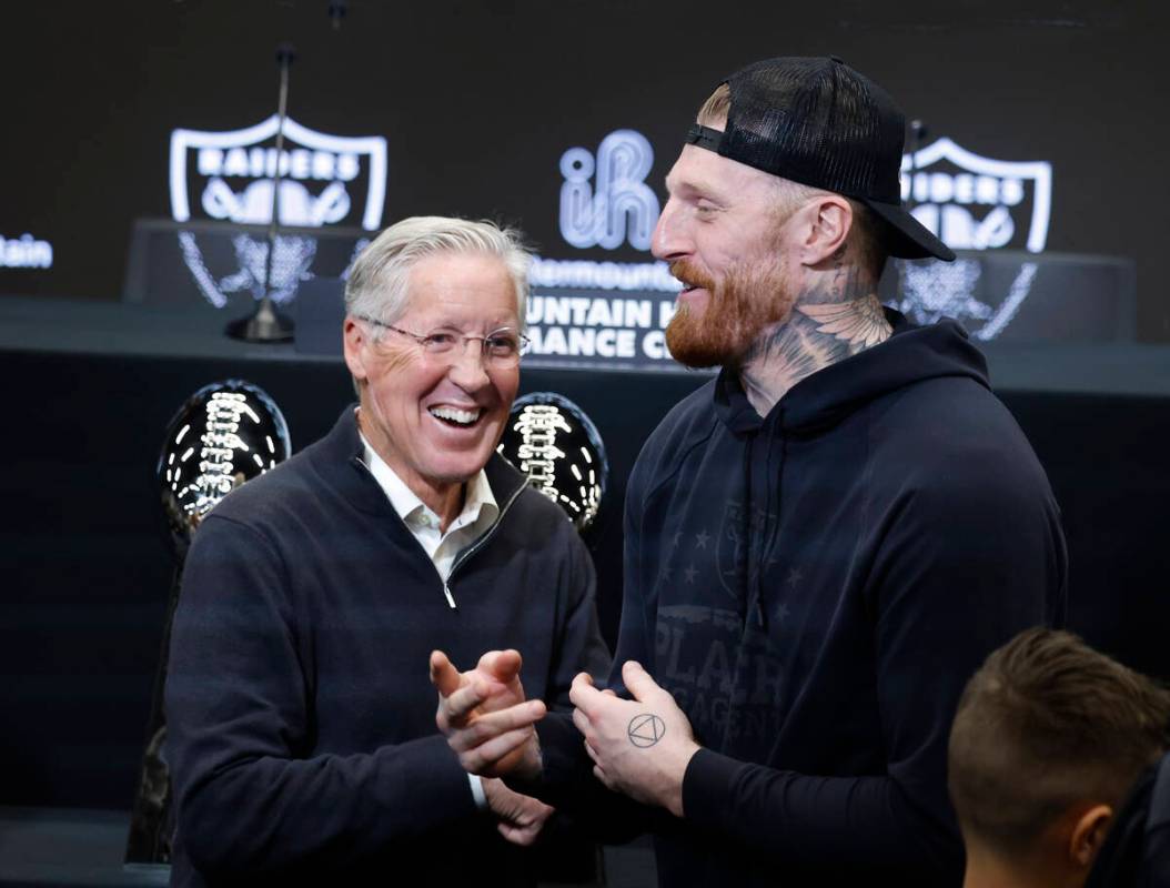 The new Raiders head coach Pete Carroll, left, and defensive end Max Crosby share laughter afte ...