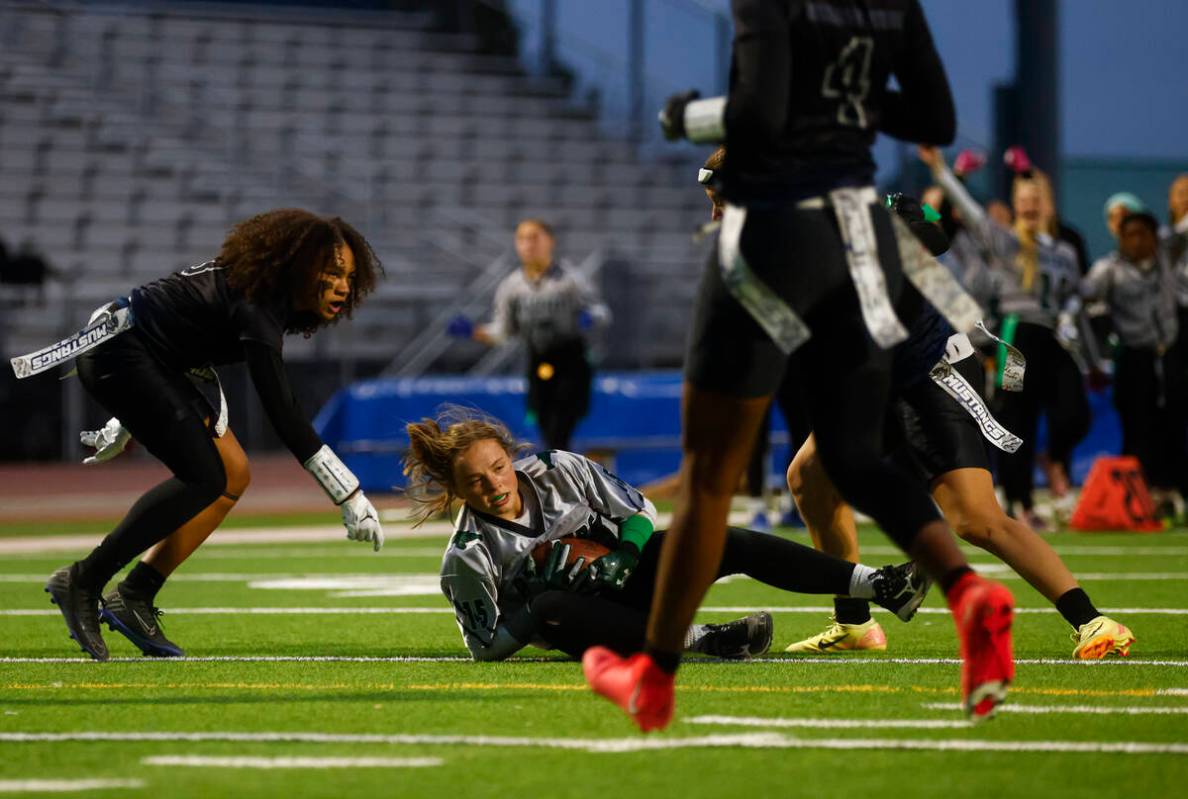 Palo Verde's Alexis Manzo (15) scores a touchdown between Shadow Ridge's Claudia Parker (3) and ...