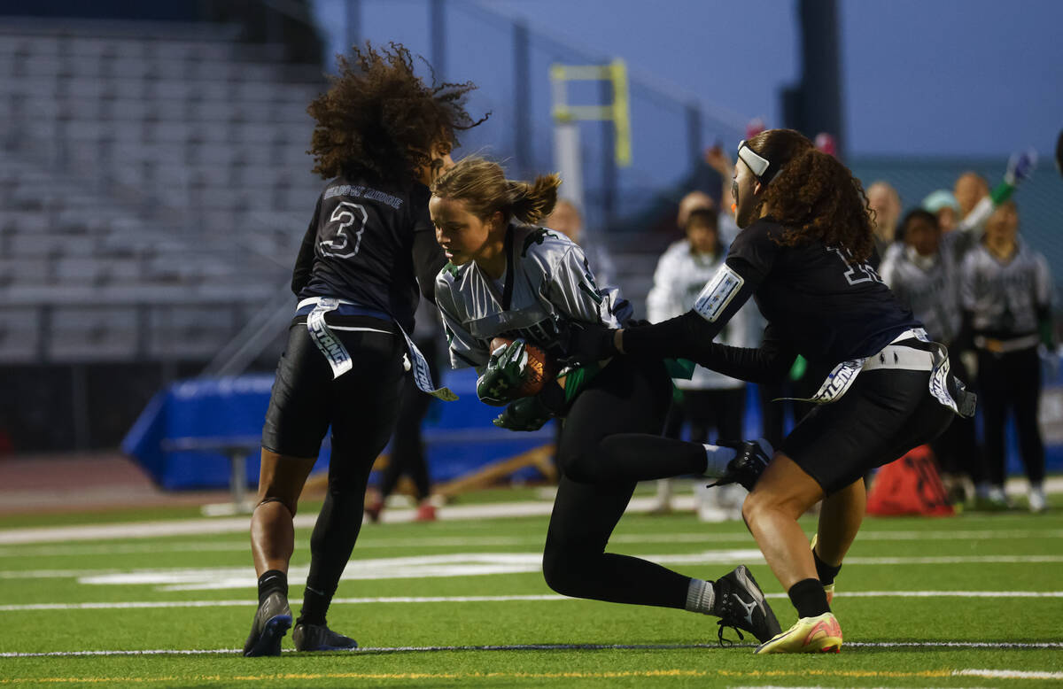 Palo Verde's Alexis Manzo (15) scores a touchdown between Shadow Ridge's Claudia Parker (3) and ...