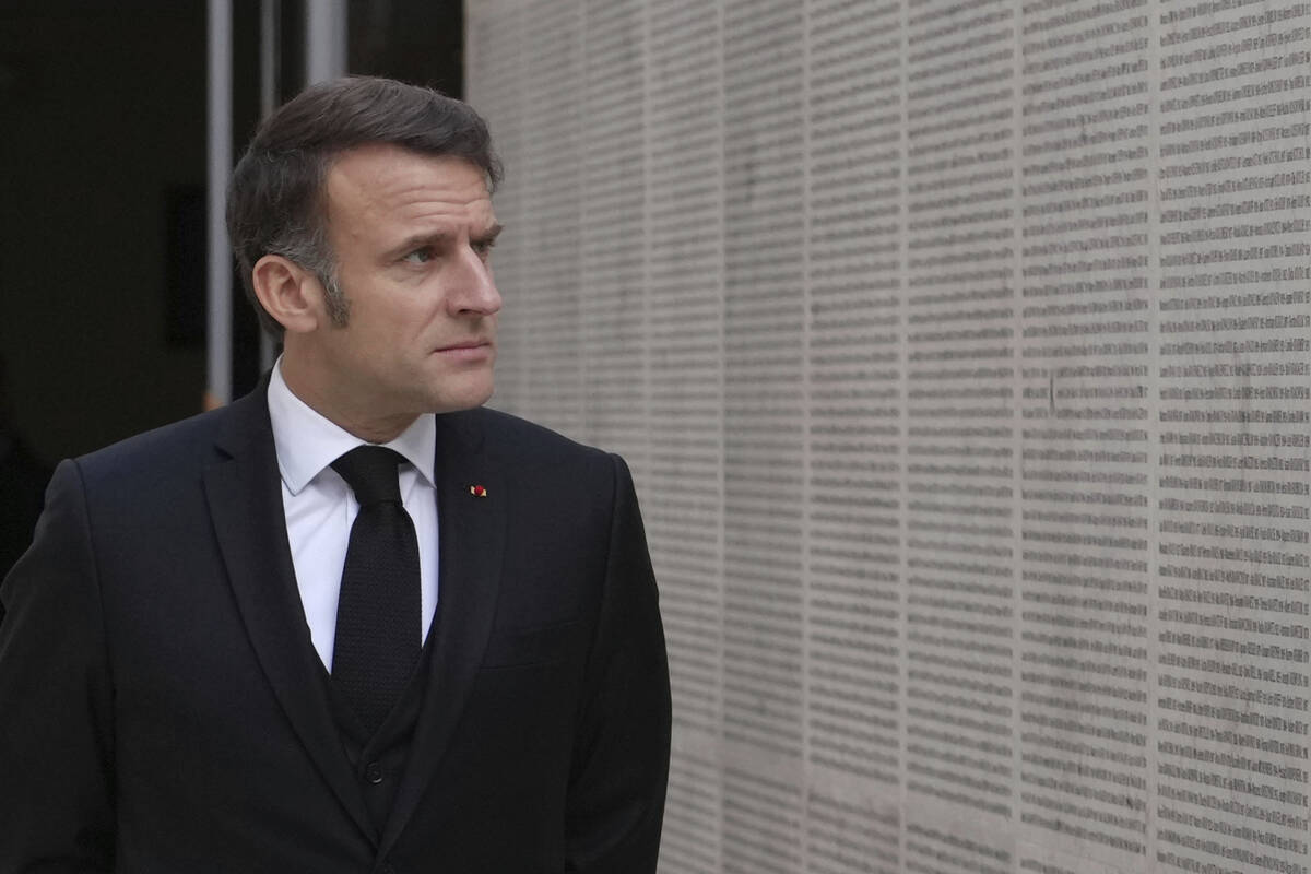 French President Emmanuel Macron walks past the wall of names during ceremonies marking the 80t ...