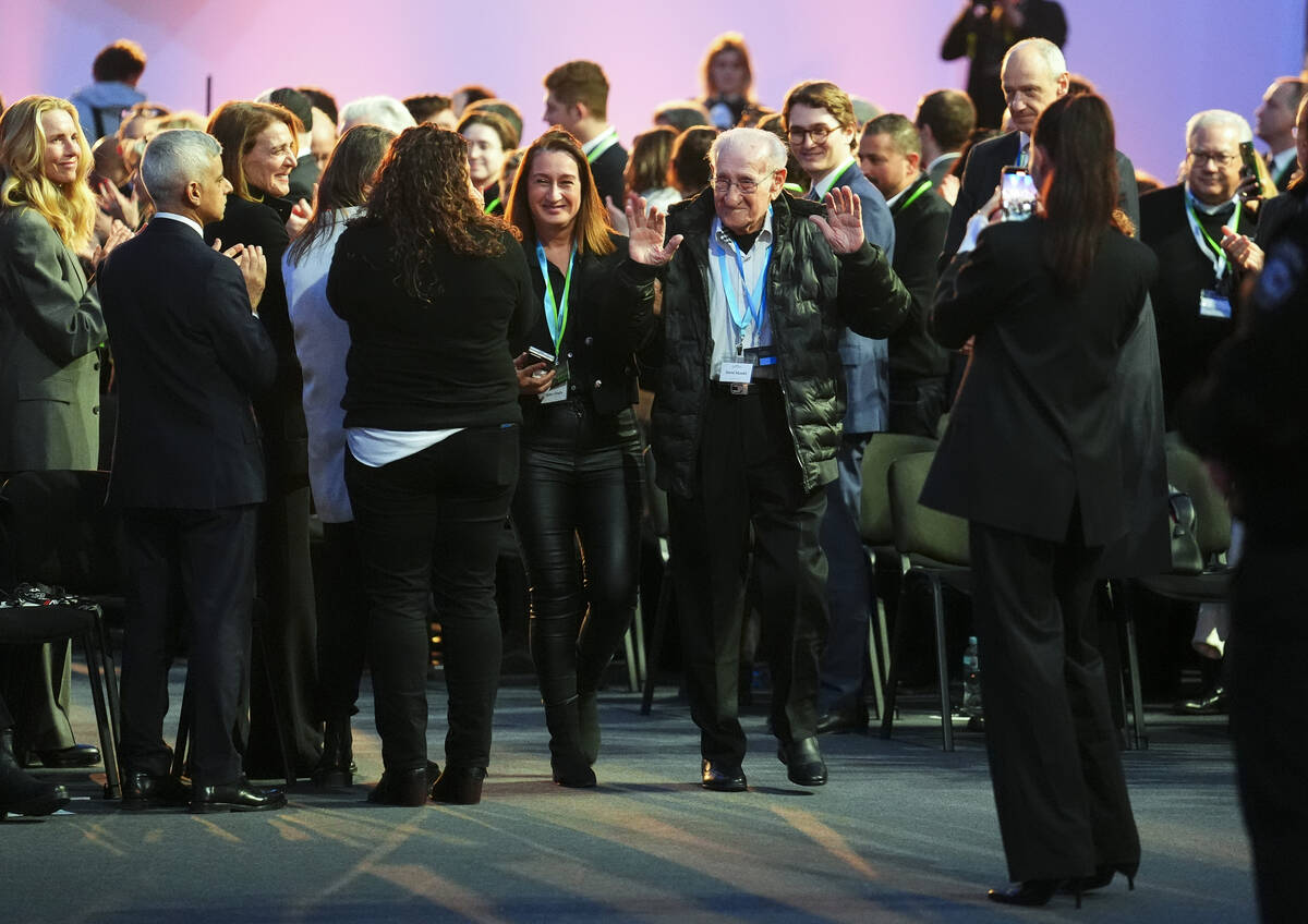Holocaust survivor David Mandel is applauded has he arrives to attend the Commemoration Ceremon ...