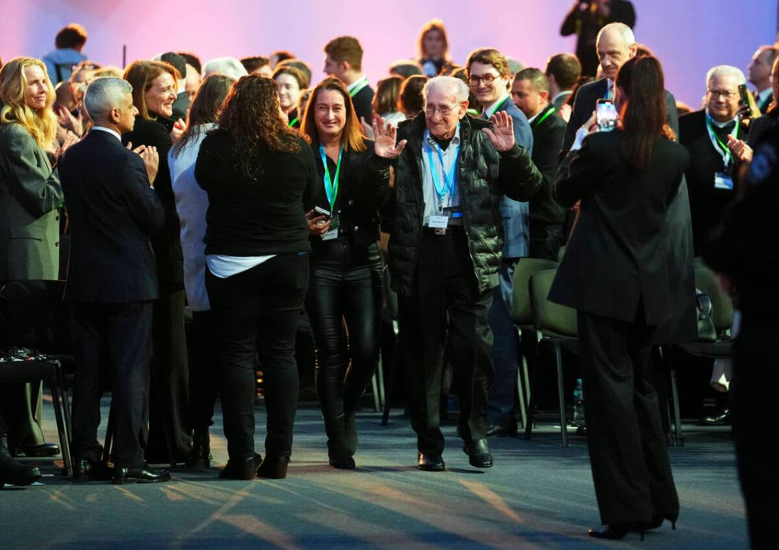 Holocaust survivor David Mandel is applauded has he arrives to attend the Commemoration Ceremon ...