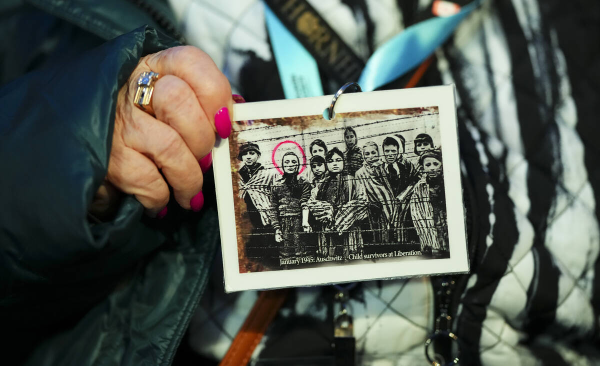 Canadian Holocaust survivor Miriam Ziegler holds up a photo of her (circled) as as she attends ...
