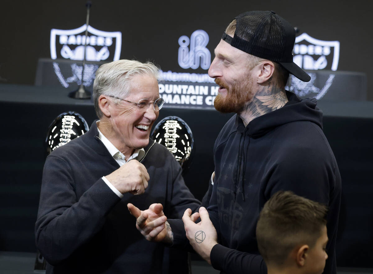 The new Raiders head coach Pete Carroll, left, and defensive end Max Crosby share laughter afte ...