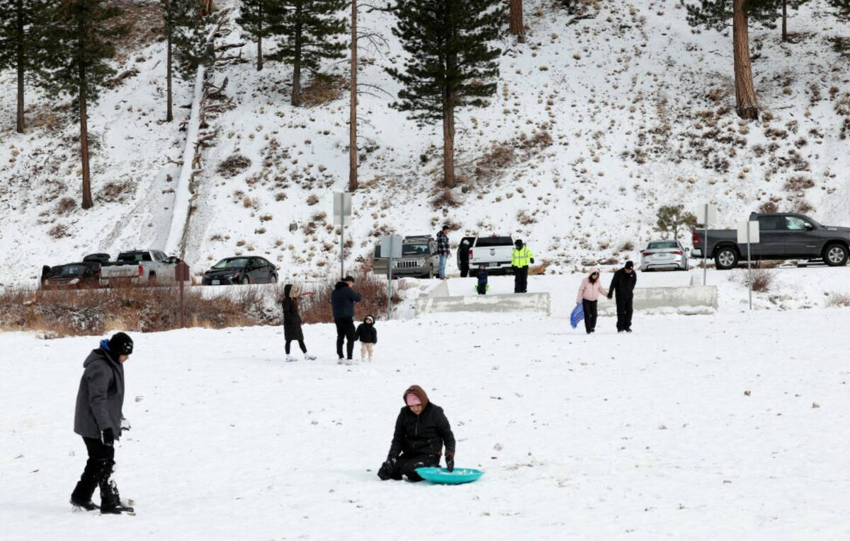 People play in a light snow in Upper Lee Meadows on Mount Charleston northwest of Las Vegas Tue ...