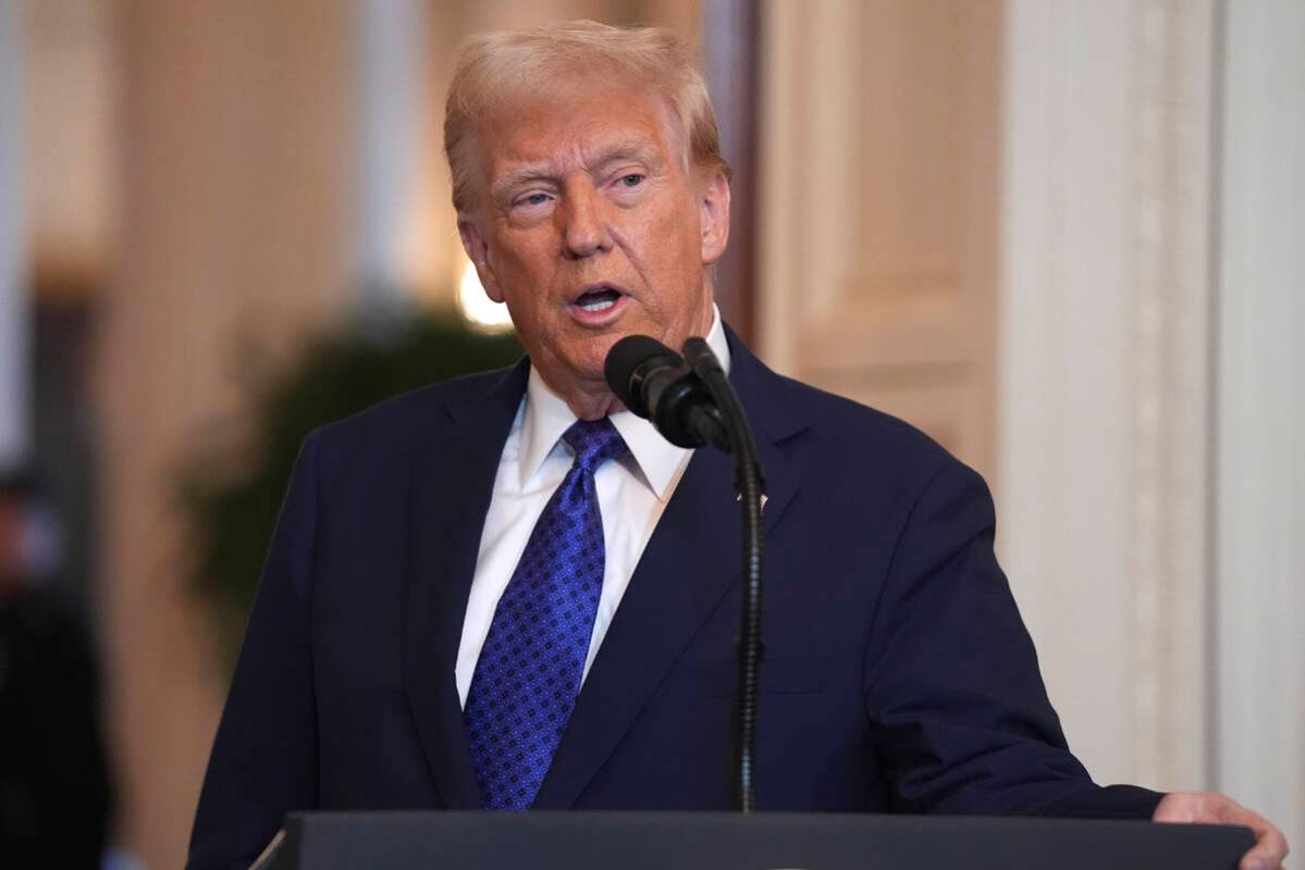 President Donald Trump speaks before signing the Laken Riley Act in the East Room of the White ...