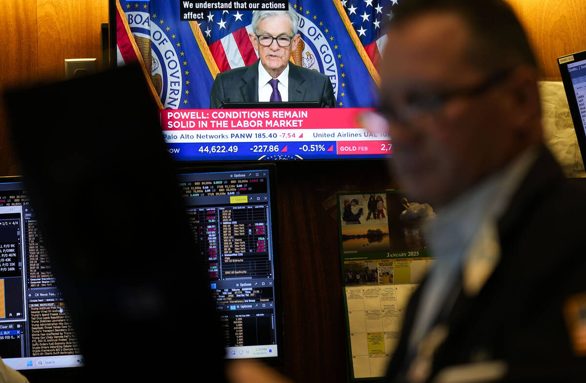 Screens display a news conference by Federal Reserve Chair Jerome Powell on the floor of the Ne ...