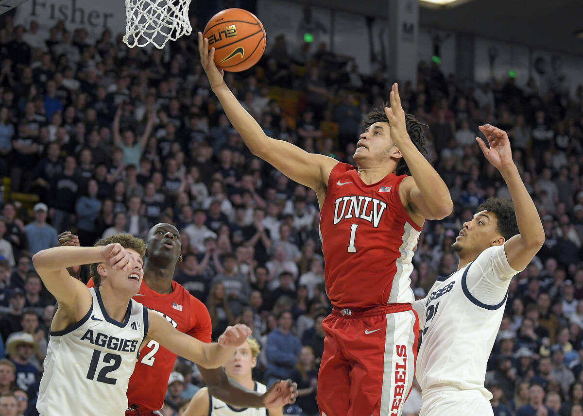 UNLV forward Jalen Hill (1) shoots the ball as Utah State guard Mason Falslev (12) and center A ...