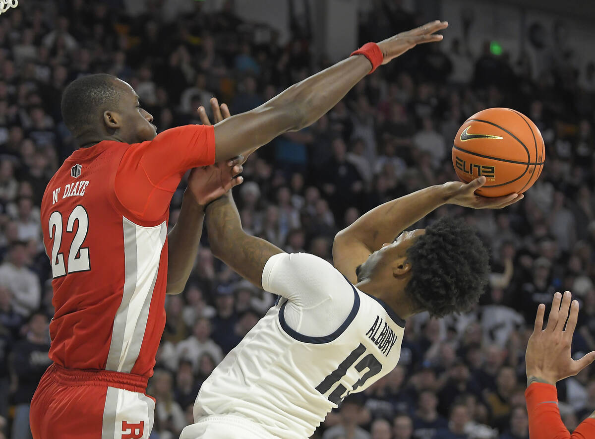 Utah State guard Deyton Albury (13) shoots the ball as UNLV forward Pape N'Diaye (22) defends i ...