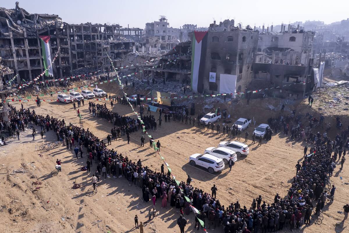 Red Cross vehicles, left, wait for the hand-over of Israeli soldier hostage Agam Berger at the ...
