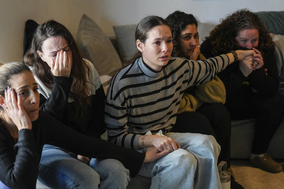 Freed hostage Shani Goren, right, and friends of Israeli hostage Arbel Yehoud react as they wat ...