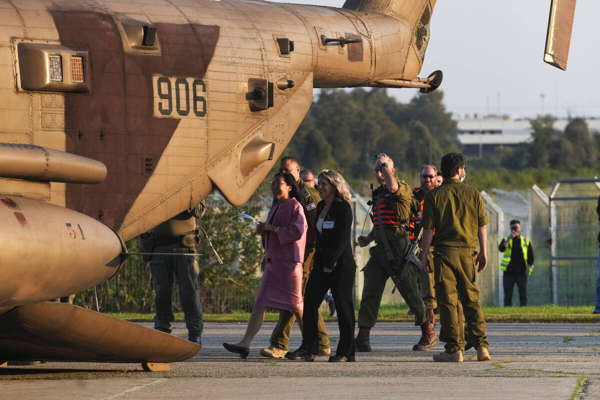 Thai ambassador to Israel Pannabha Chandraramya, left, arrives to an Israeli military helicopte ...