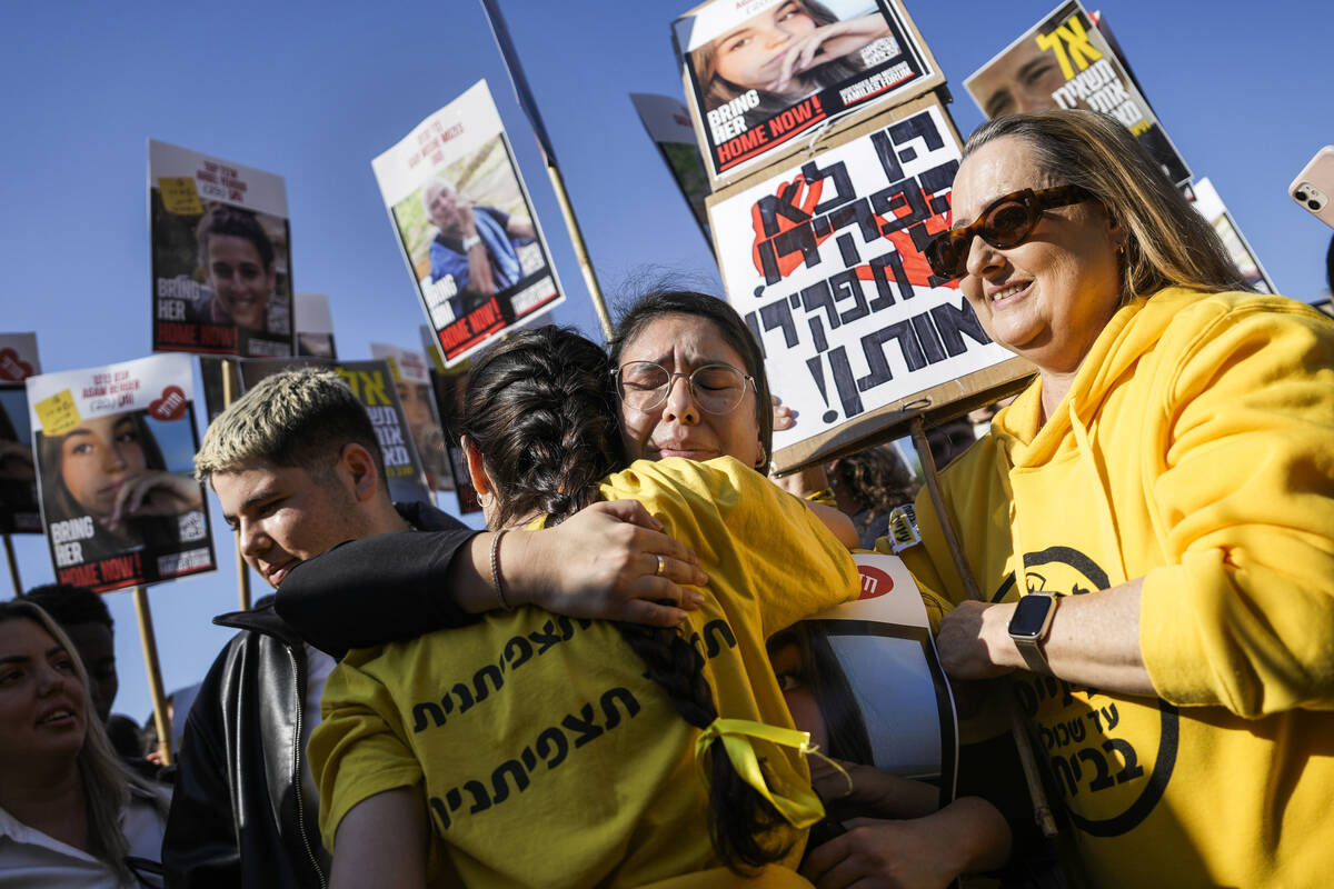 People react as they watch broadcast of the release of Israeli soldier Agam Berger, one of eigh ...