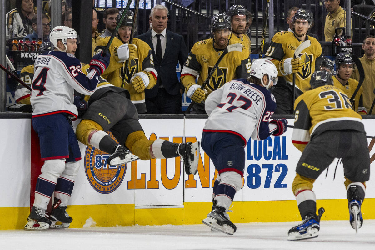Golden Knights center Tomas Hertl (48) is checked into the box by Columbus Blue Jackets right w ...