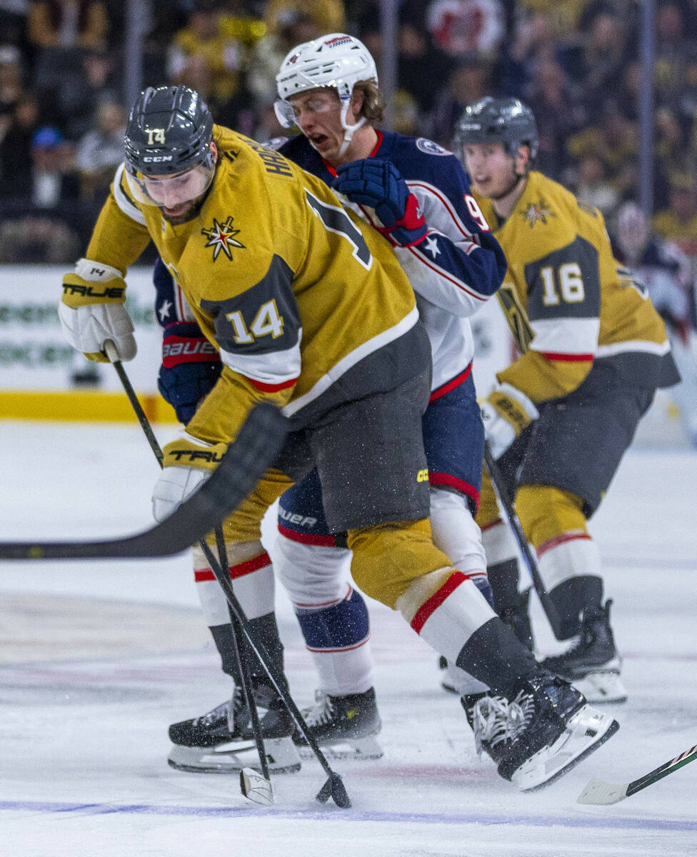 Golden Knights defenseman Nicolas Hague (14) takes control of the puck as Columbus Blue Jackets ...
