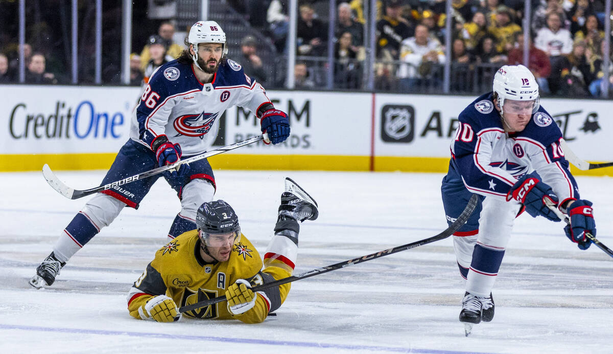 Golden Knights defenseman Brayden McNabb (3) is taken down by Columbus Blue Jackets left wing D ...