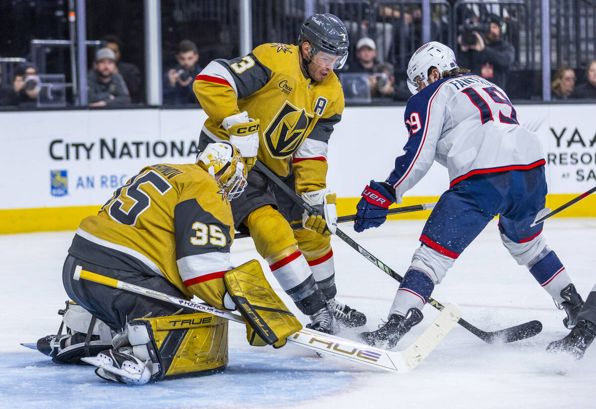 Golden Knights goaltender Ilya Samsonov (35) and Brayden McNabb (3) look to stop a shot attemp ...