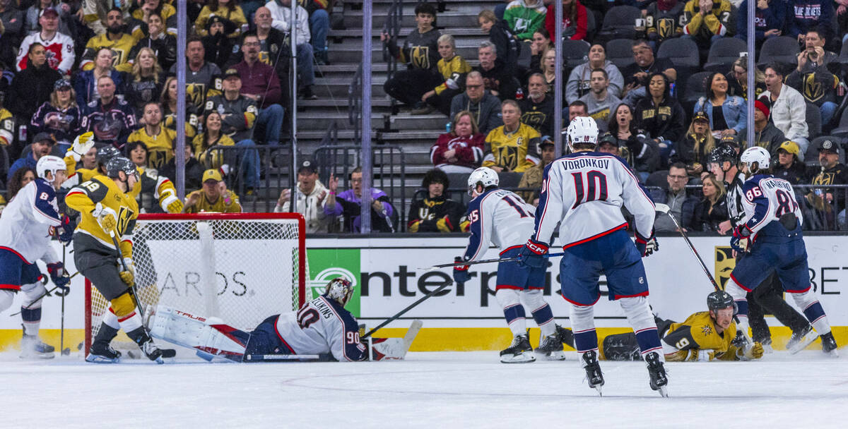 Golden Knights center Jack Eichel (9) is down on the ice after a shot on goal against Columbus ...