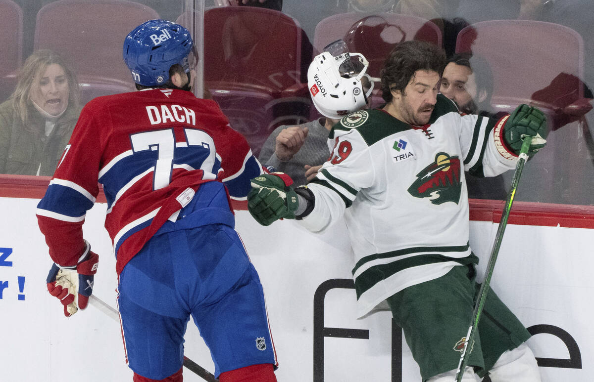 Minnesota Wild's Frederick Gaudreau, right, loses his helmet as he is checked by Montreal Canad ...