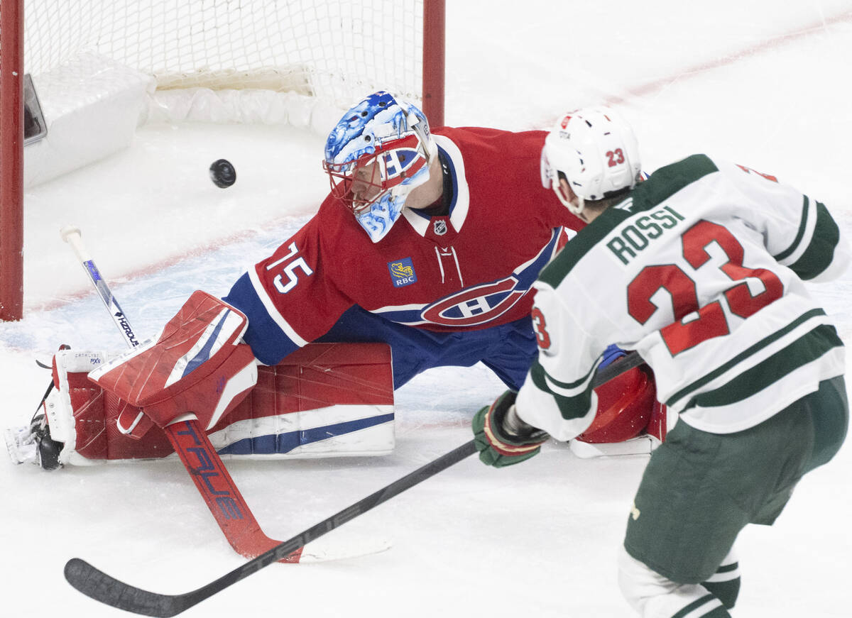 Minnesota Wild's Marco Rossi (23) scores against Montreal Canadiens goaltender Jakub Dobes (75) ...