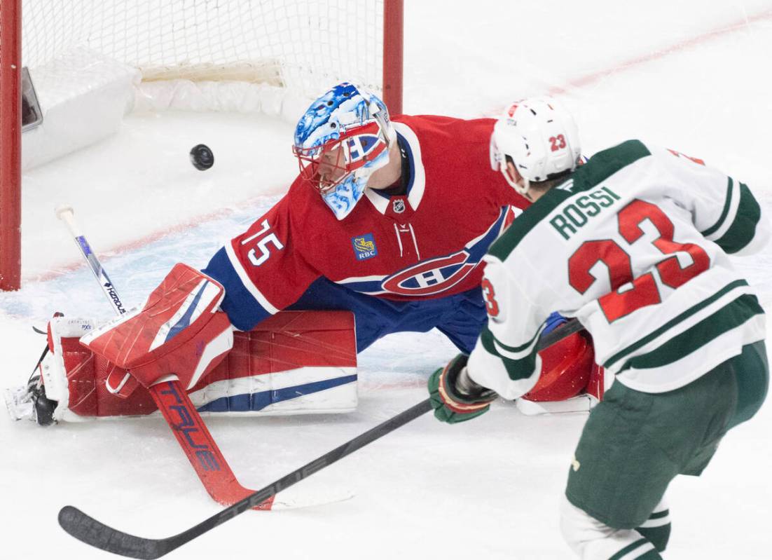 Minnesota Wild's Marco Rossi (23) scores against Montreal Canadiens goaltender Jakub Dobes (75) ...