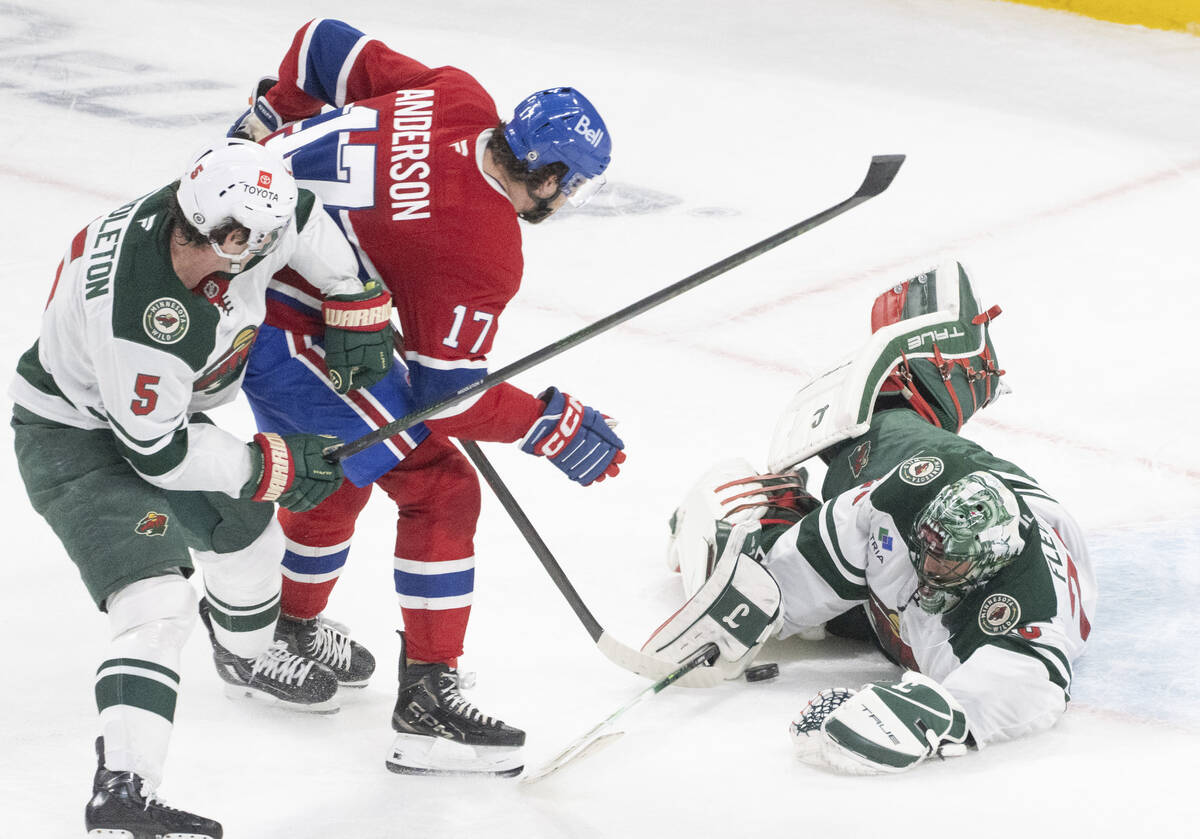 Minnesota Wild goaltender Marc-Andre Fleury, right, makes a save against Montreal Canadiens' Jo ...