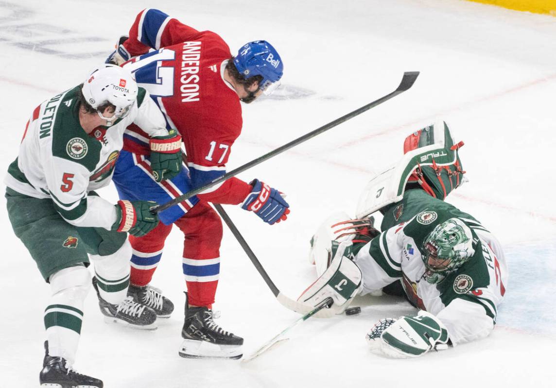 Minnesota Wild goaltender Marc-Andre Fleury, right, makes a save against Montreal Canadiens' Jo ...