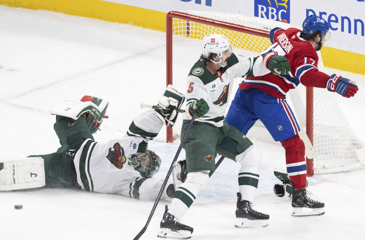 Minnesota Wild goaltender Marc-Andre Fleury, left, makes a save against Montreal Canadiens' Jos ...