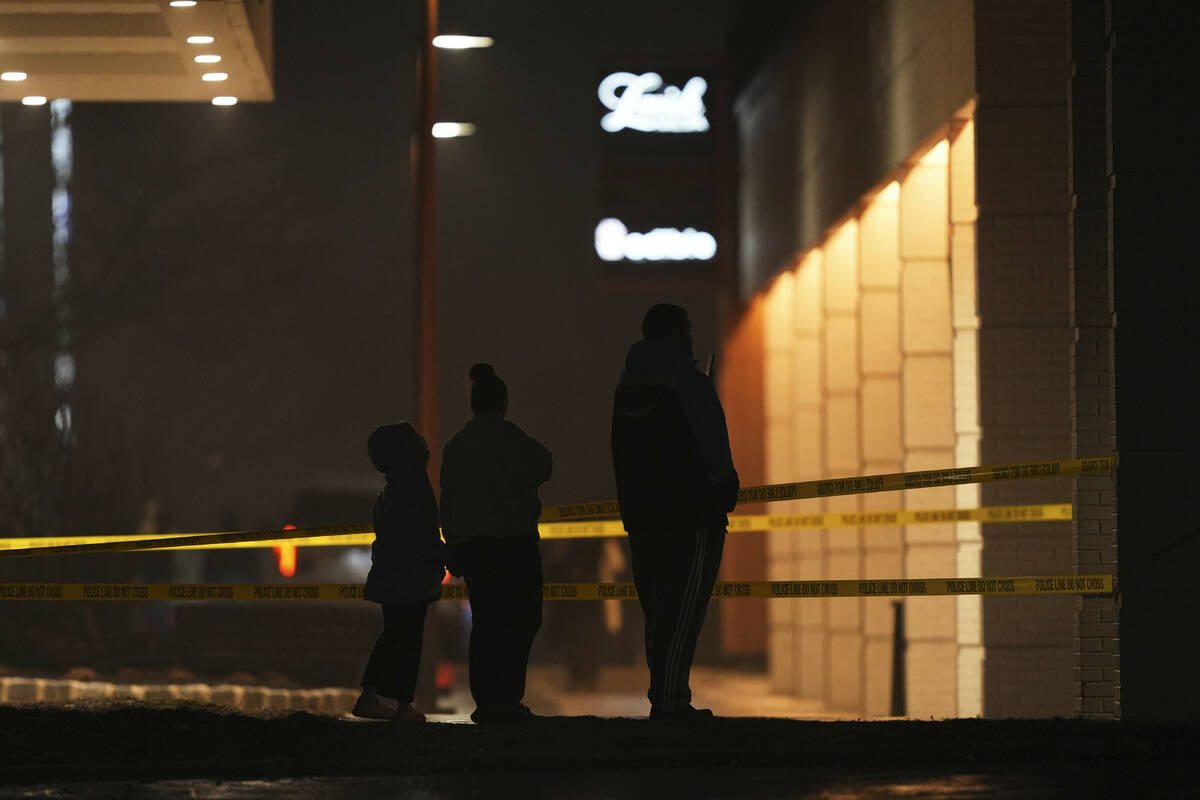Bystanders watch as first responders work the scene after what witnesses say was a plane crash ...