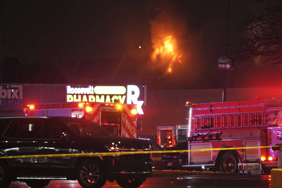 First responders work the scene after what witnesses say was a plane crash in Philadelphia, Fri ...