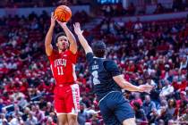 UNLV Rebels guard Dedan Thomas Jr. (11) elevates to shoot over UNR guard Jarod Lucas (2) during ...