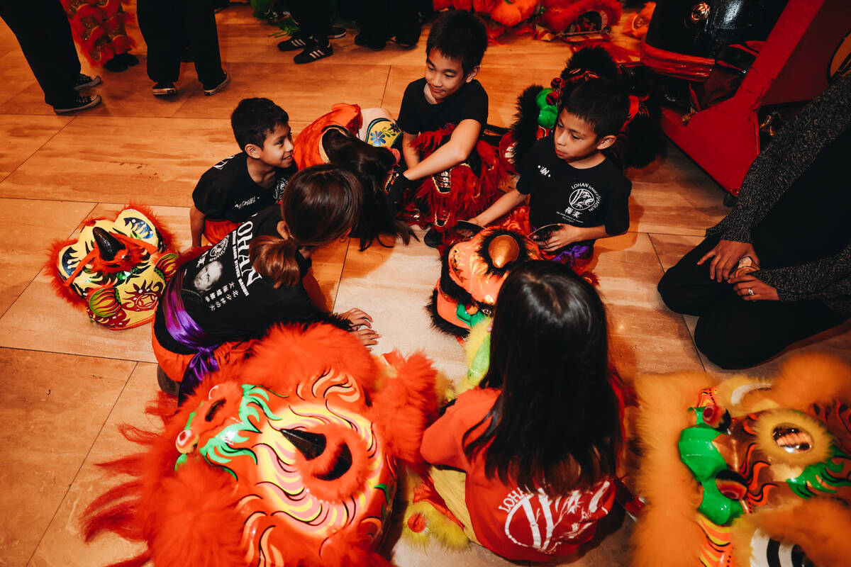 Baby lion dancers socialize before taking part in a Lunar New Year parade featuring traditional ...