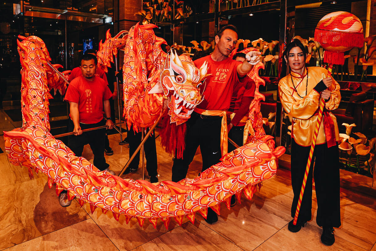 Dragon dancers ready themselves to perform during a Lunar New Year parade featuring traditional ...