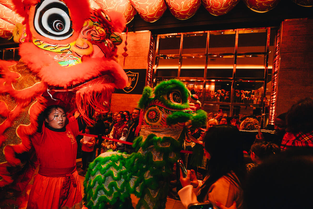 Dancing lions perform during a Lunar New Year parade featuring traditional dances at M Resort S ...