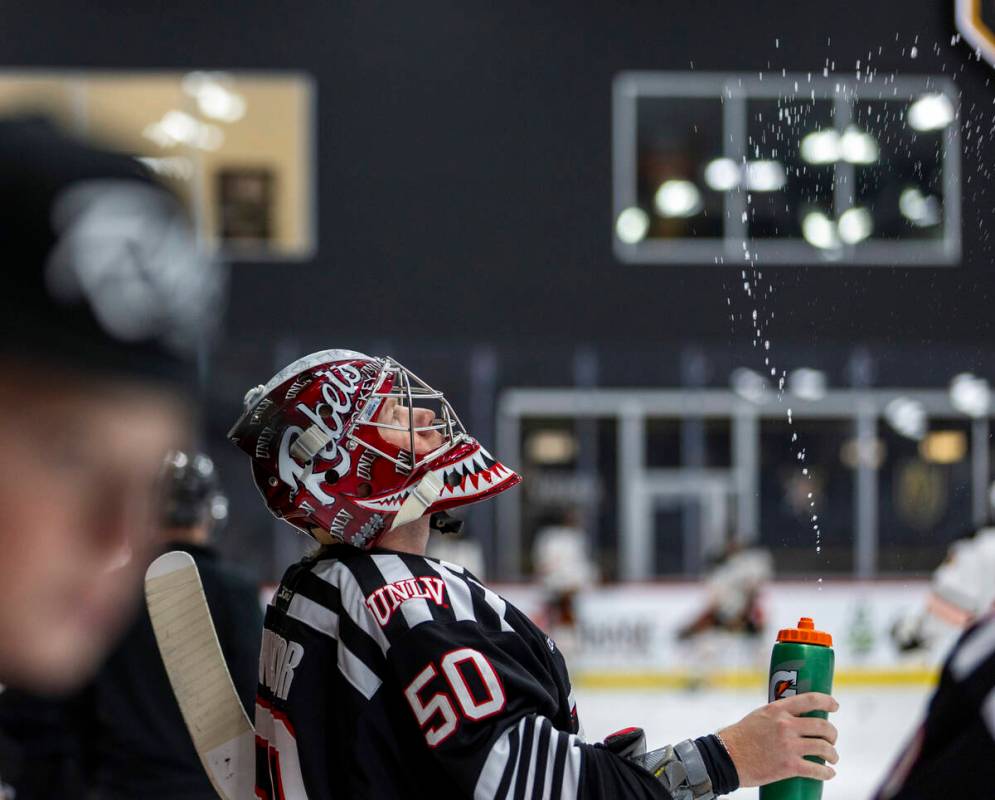UNLV goalie Luke Fundator (50) sprays his traditional water in the air before the club hockey t ...