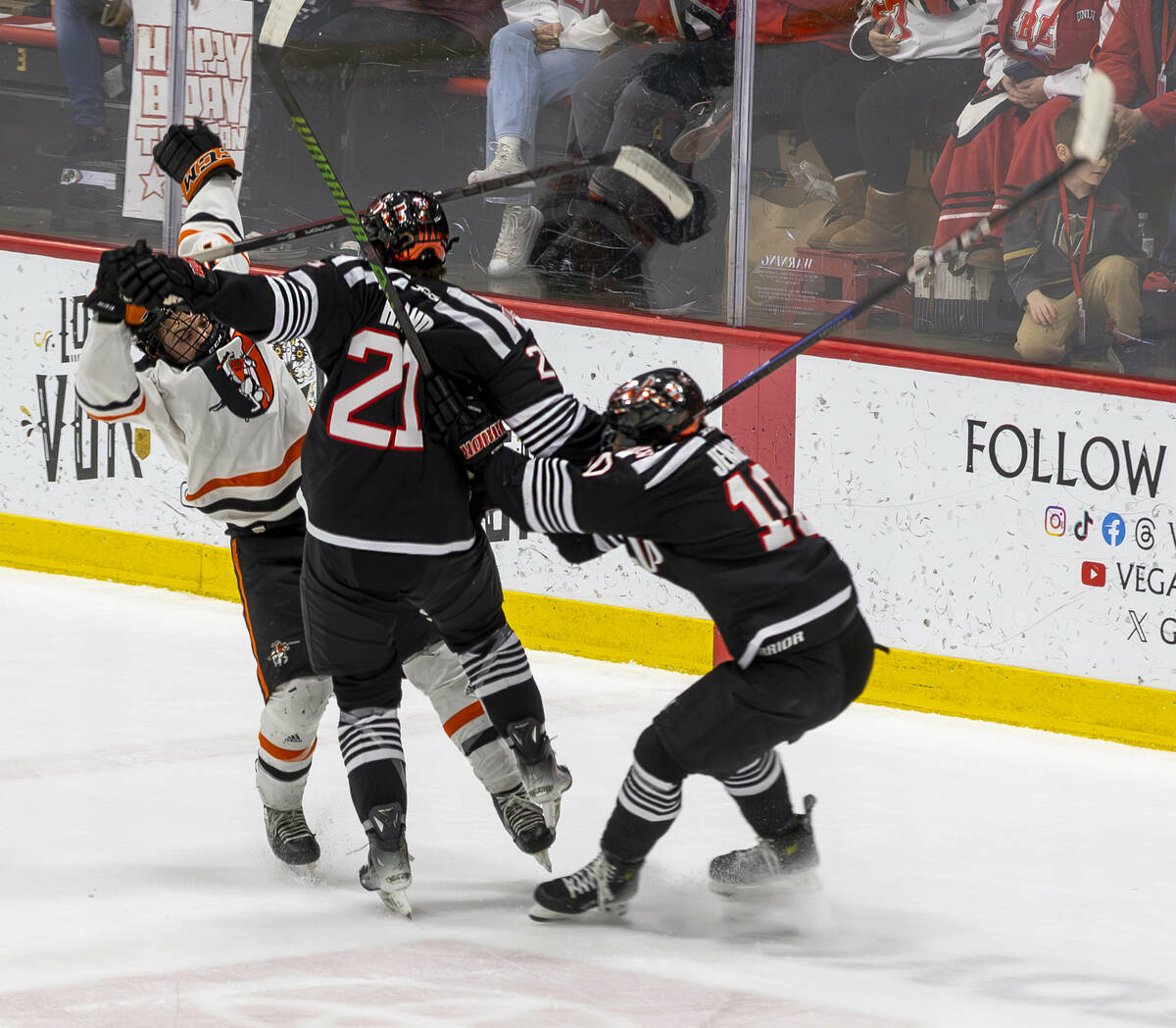 UNLV forward Tristan Rand collides with Jamestown Jimmies defenseman Carter Johnson (16) and UN ...