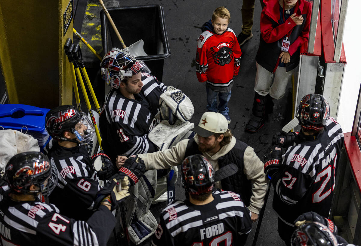 A young UNLV fan watches the players as they ready to take the ice for the second period agains ...