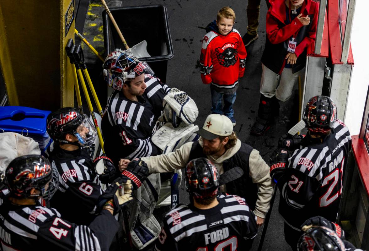 A young UNLV fan watches the players as they ready to take the ice for the second period agains ...