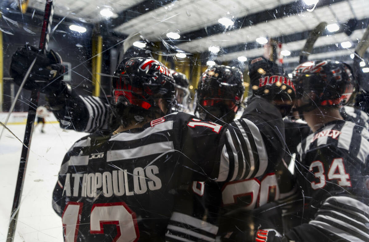 UNLV players celebrate a goal against Jamestown Jimmies players during the second period of the ...