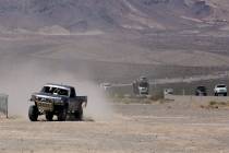 An off roader churns up a trail of dust on the dry lake bed in Eldorado Valley Friday May 25, 2 ...