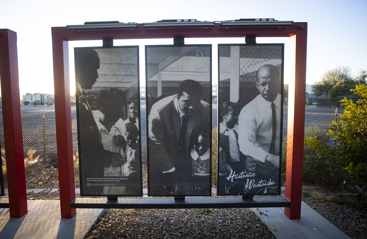 Muhammad Ali and Theron Goynes visit an elementary school as seen in a 1965 photo on display at ...
