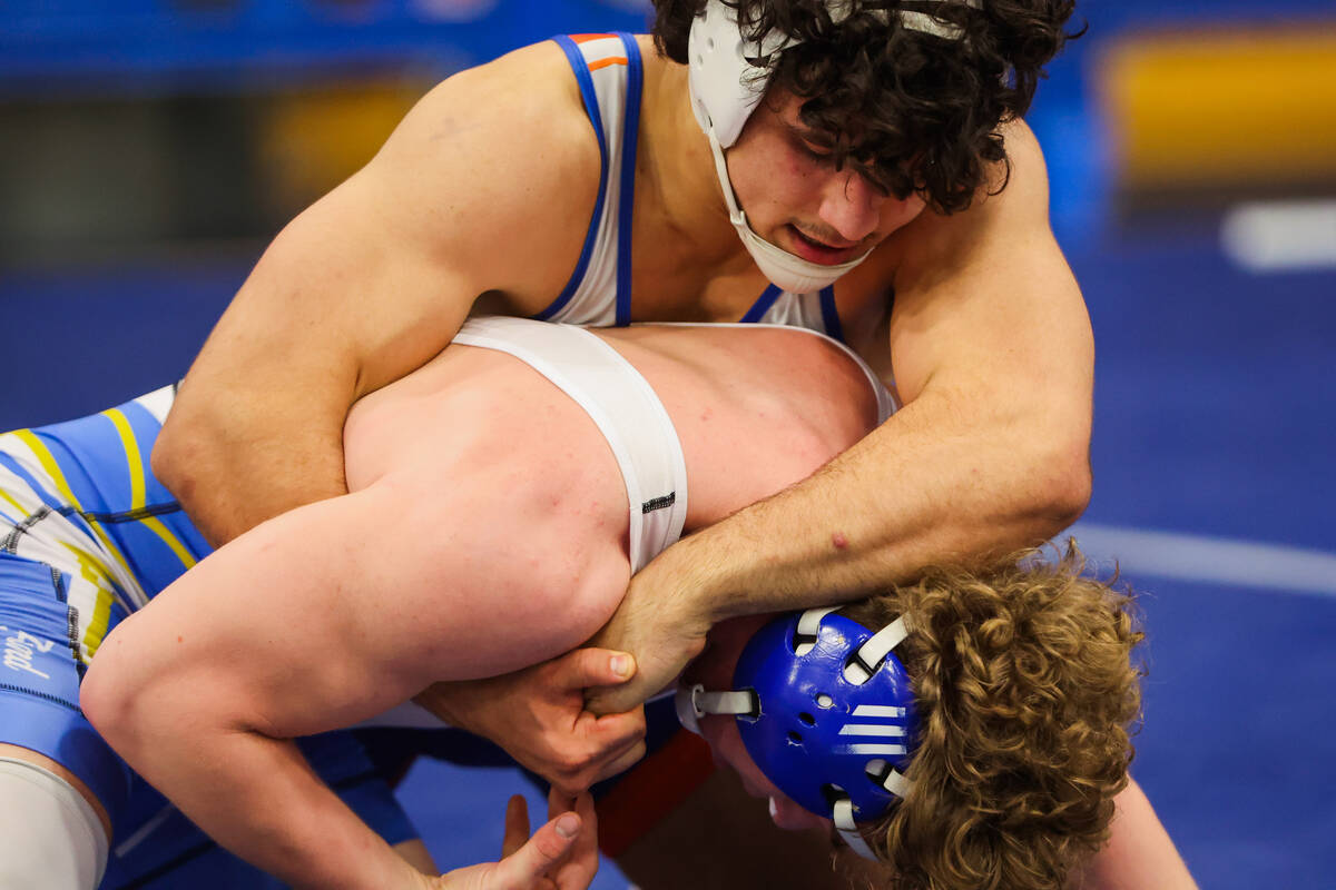 Kage Mir of Bishop Gorman (top) keeps a hold on Foothill's Lloyd Vincent during the Class 5A So ...