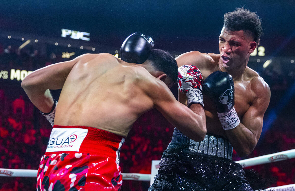 David Benavidez takes a shot to the side of the head by David Morrell Jr. in round 2 of their W ...