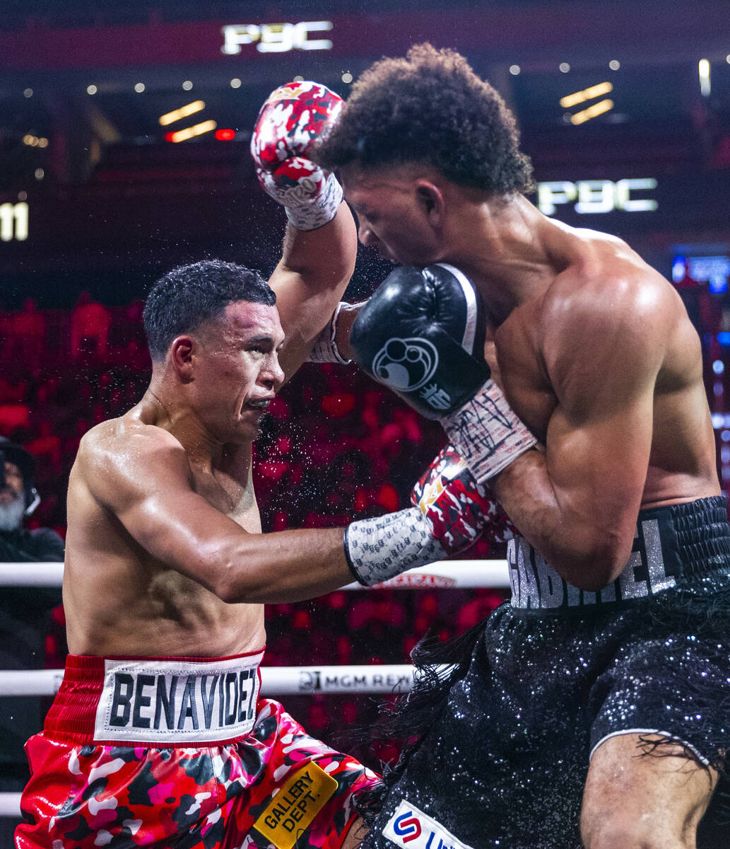 David Benavidez connects with the body of David Morrell Jr. in round 11 of their WBC and WBA ti ...