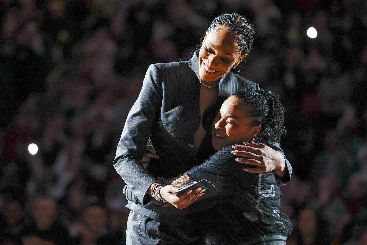 A'ja Wilson, left, and South Carolina head coach Dawn Staley embrace during a ceremony for Wils ...