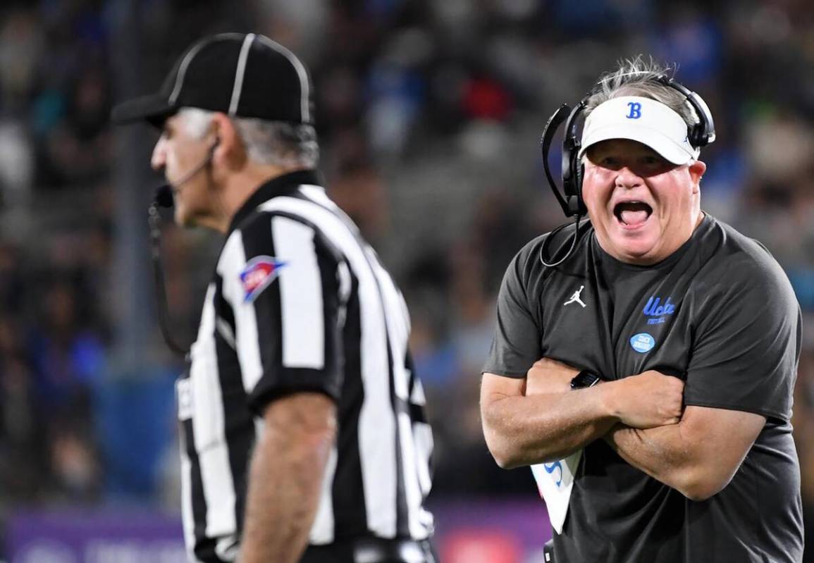 UCLA had coach Chip Kelly, right, has a few words for an official in the second quarter at the ...