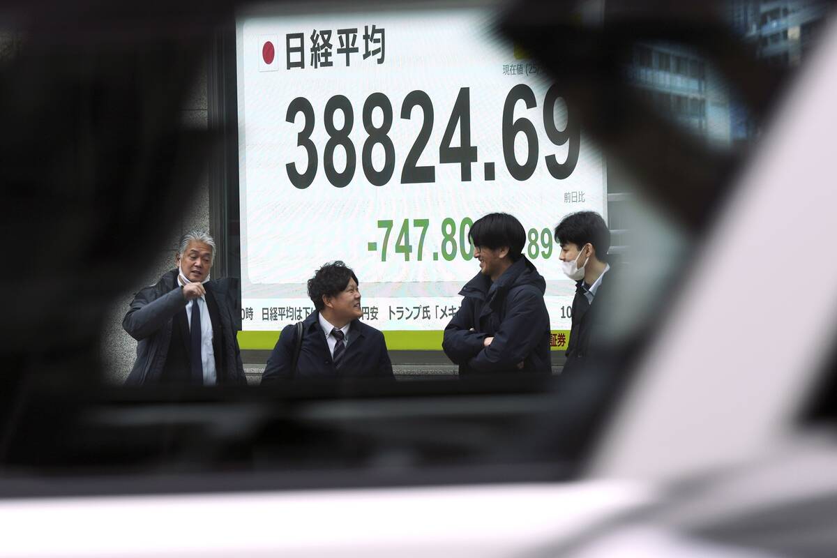 An electronic stock board showing Japan's Nikkei index at a securities firm is seen through the ...