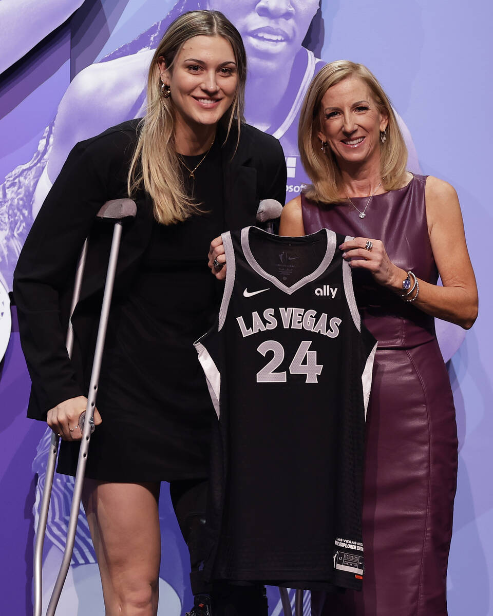 Virginia Tech's Elizabeth Kitley, left, poses for a photo with WNBA commissioner Cathy Engelber ...