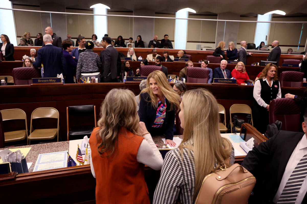 Assembly member Venicia Considine, D-Las Vegas, visits with friends on the Assembly floor in th ...